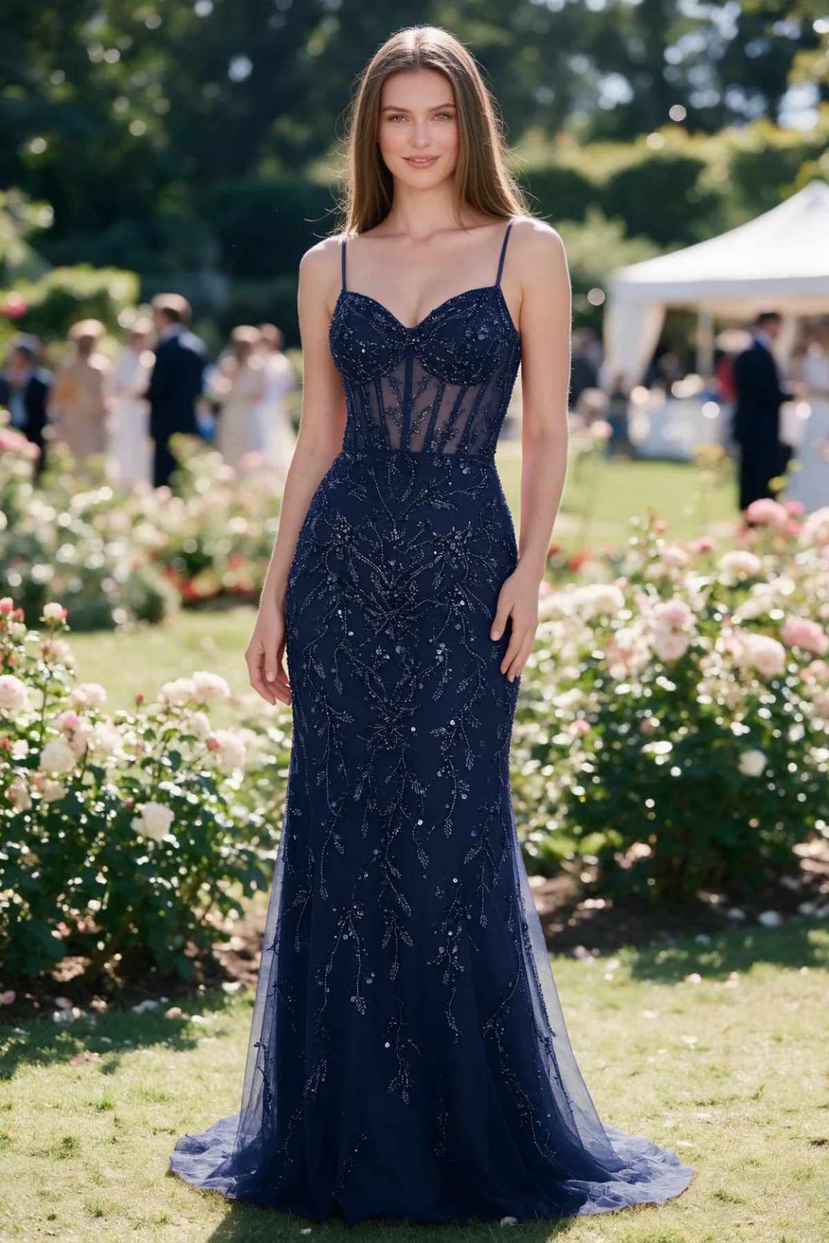 Aurelia navy sequin corset maxi dress shown from the front in a garden setting