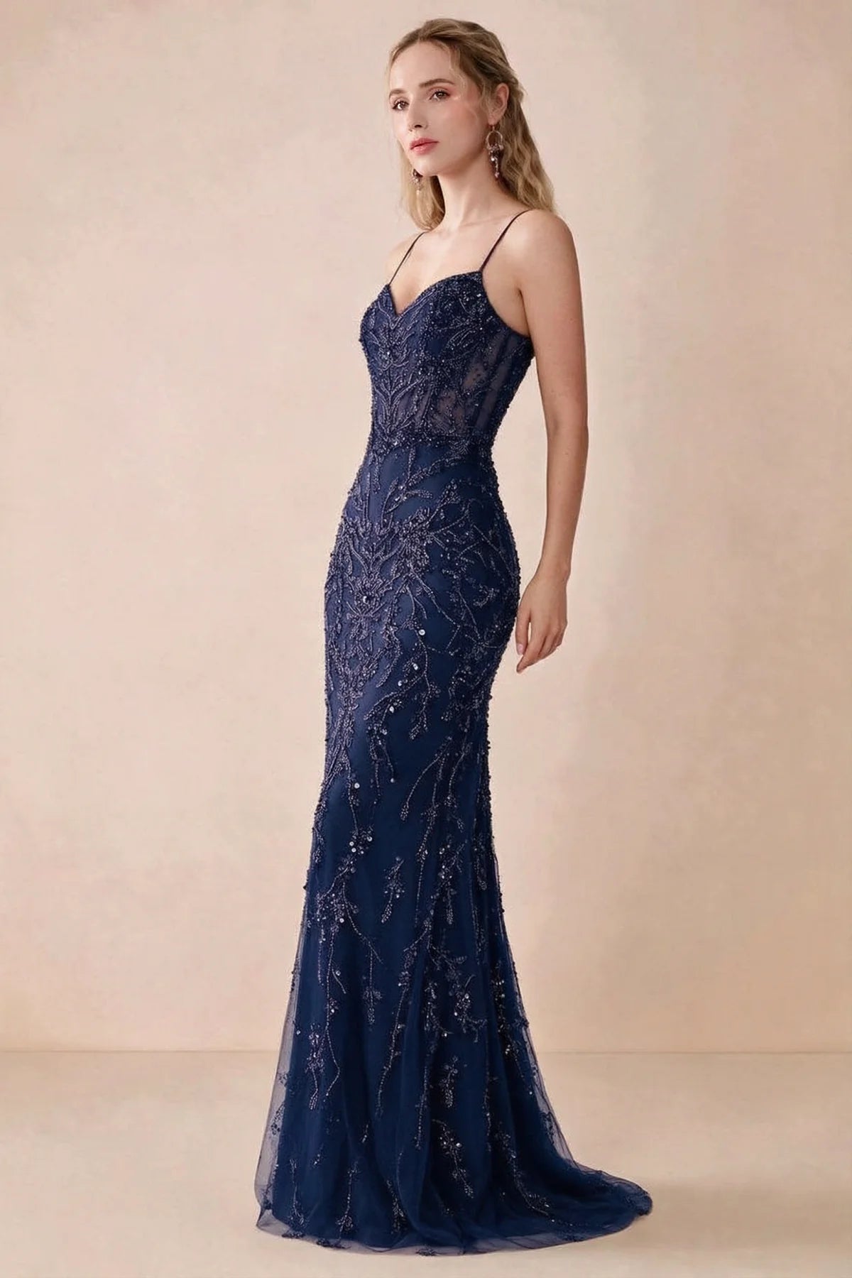 Side view of Aurelia navy sequin maxi dress showing the fitted hips and flared hem
