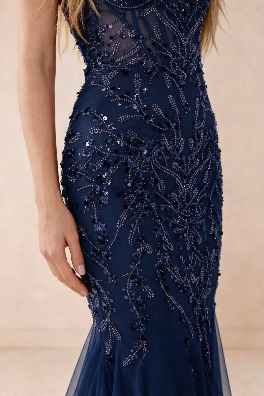 Detail of Aurelia navy embroidered sequin pattern across the fitted waist and hip