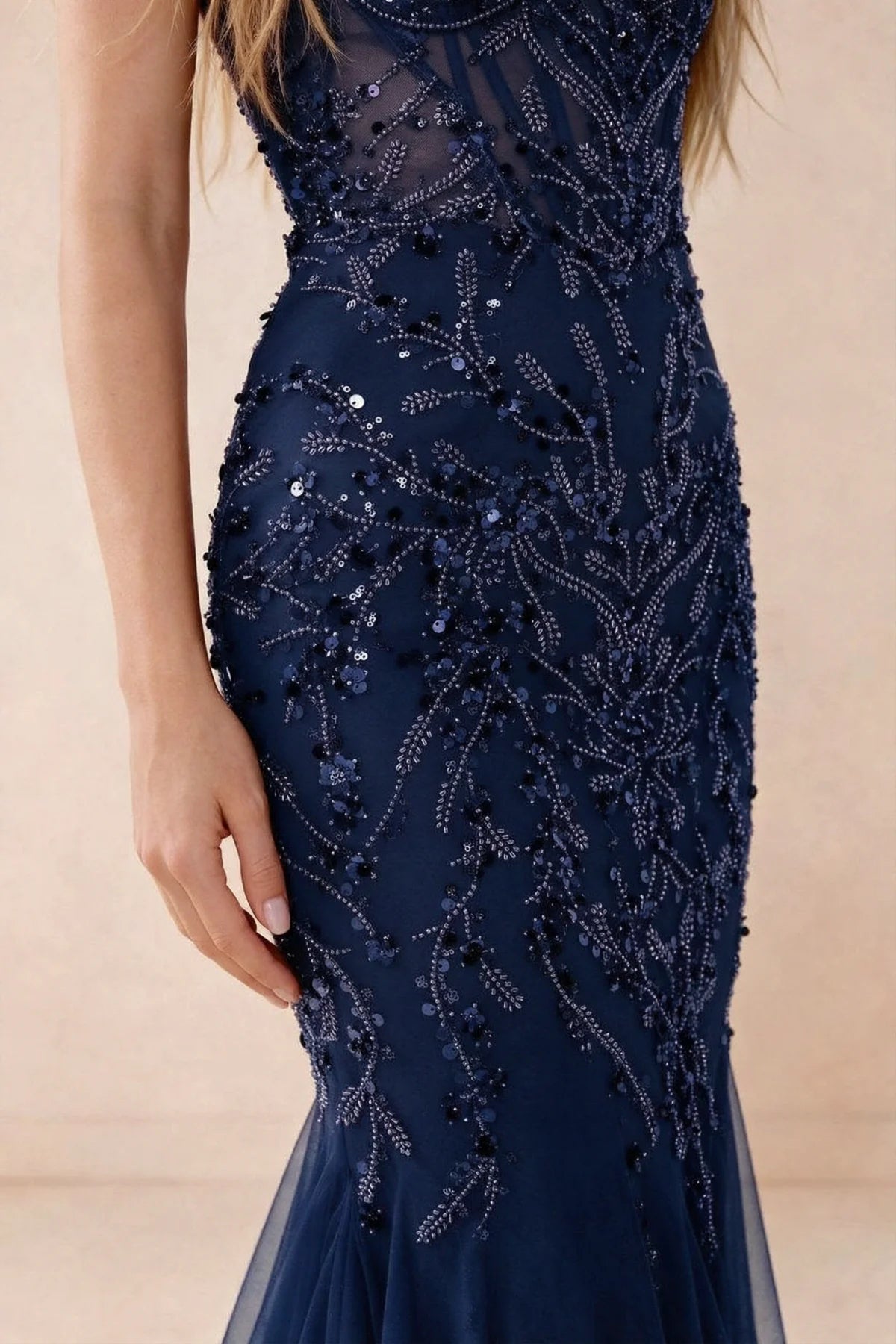 Detail of Aurelia navy embroidered sequin pattern across the fitted waist and hip