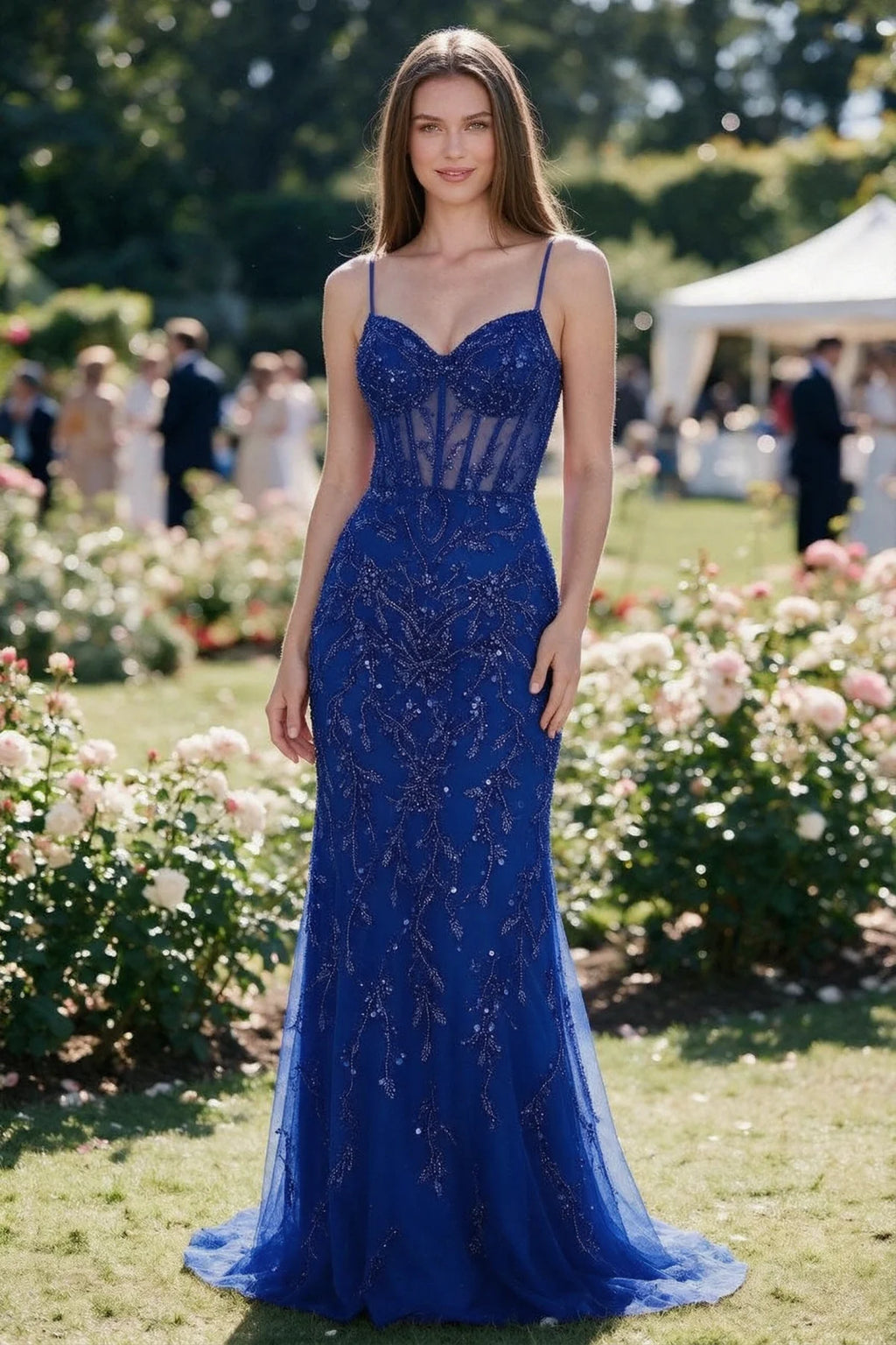 Aurelia royal blue sequin corset maxi dress shown from the front in a garden setting