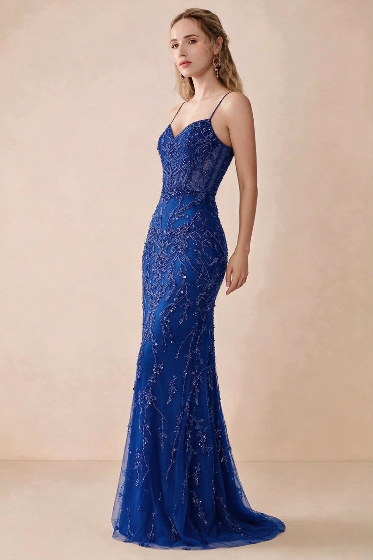 Side view of Aurelia royal blue sequin maxi dress showing the fitted hips and flared hem