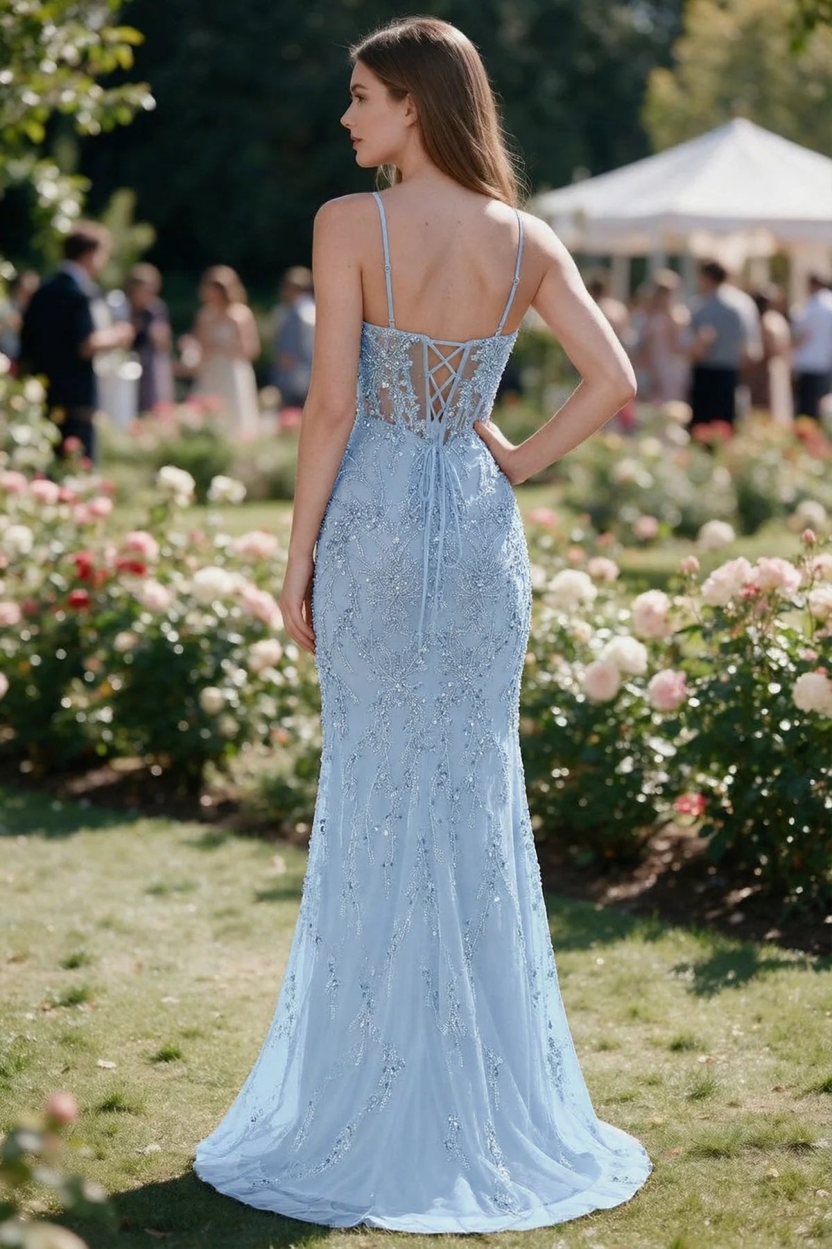 Rear garden view of Aurelia sky blue mermaid dress with an open upper back and lace-up waist