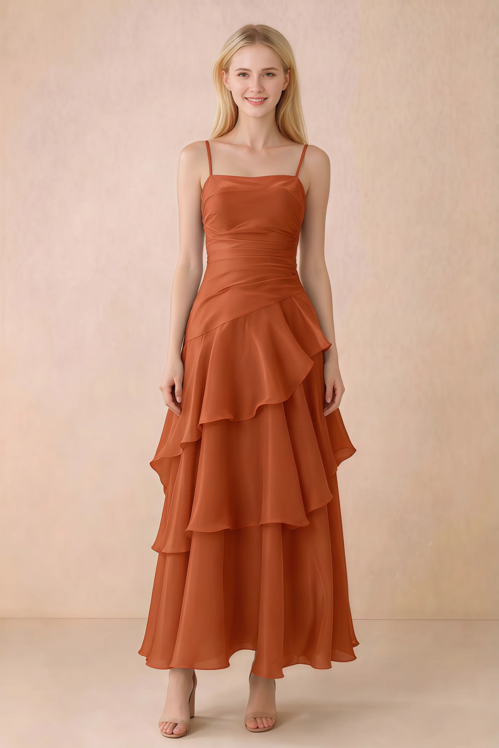 Front view of Ava burnt orange chiffon maxi dress with thin straps, a fitted bodice and cascading ruffle tiers