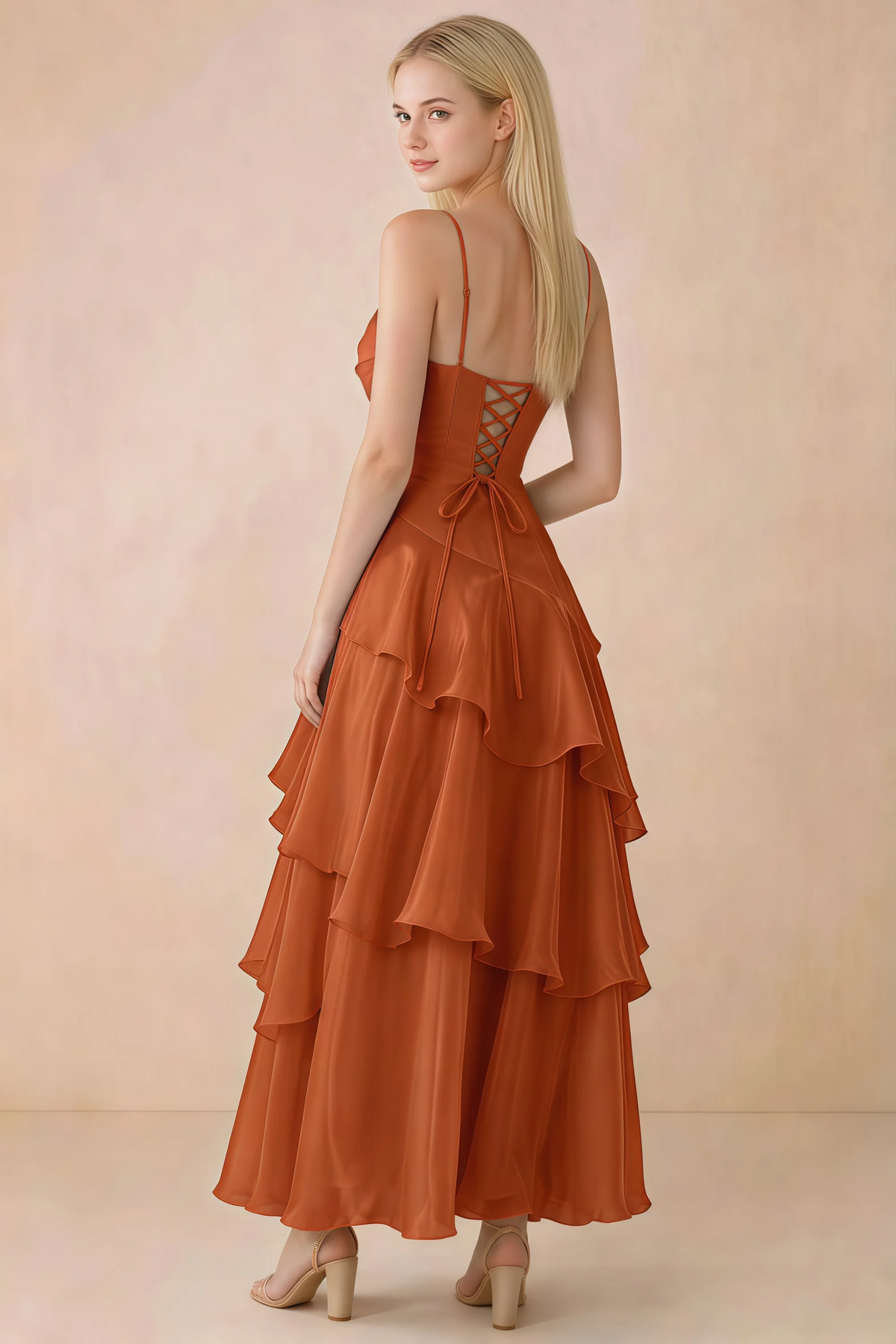 Back view of Ava burnt orange tiered ruffle dress showing fine shoulder straps and crossed back lacing