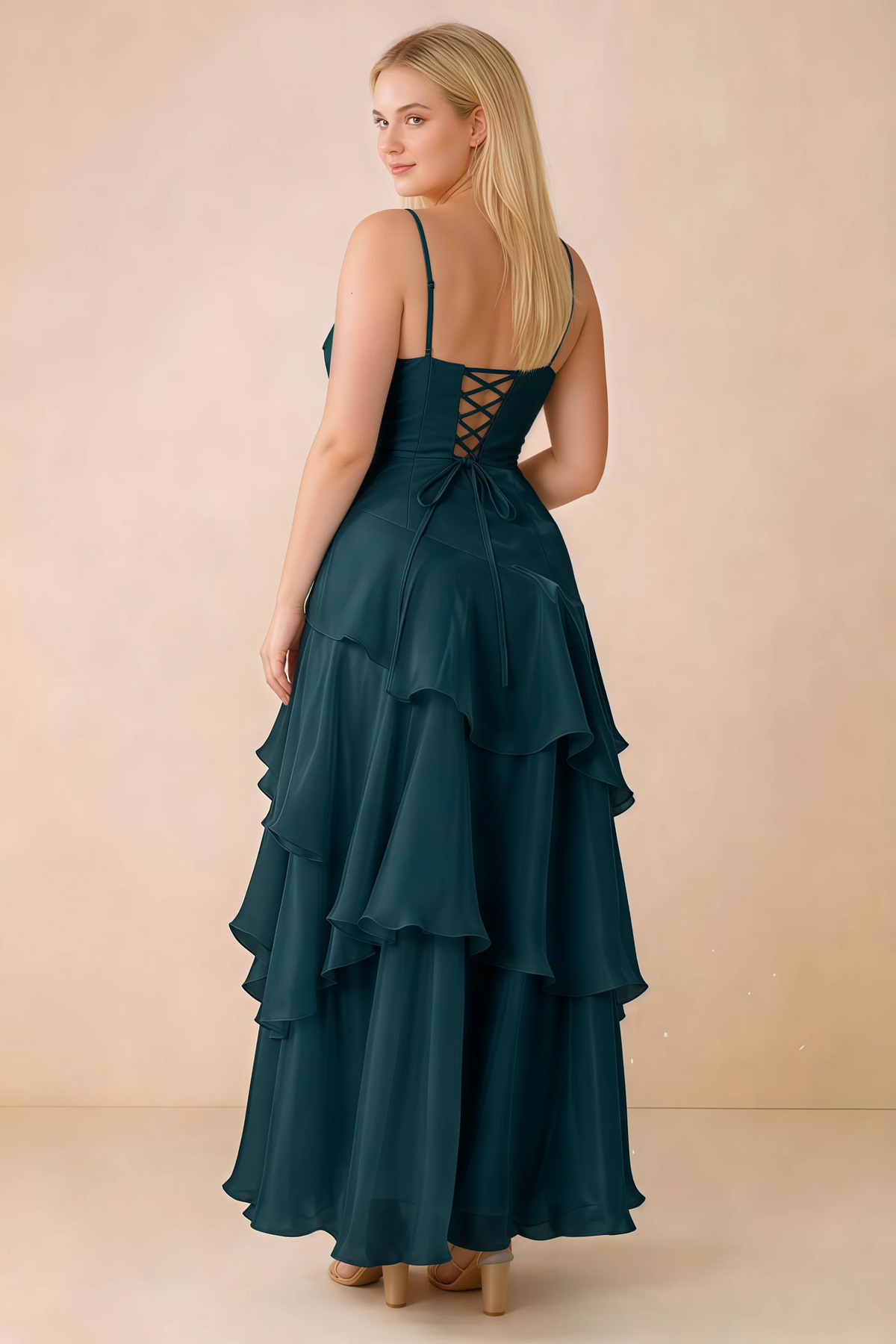 Rear studio view of Ava emerald green maxi dress showing the lace-up bodice and long tiered skirt