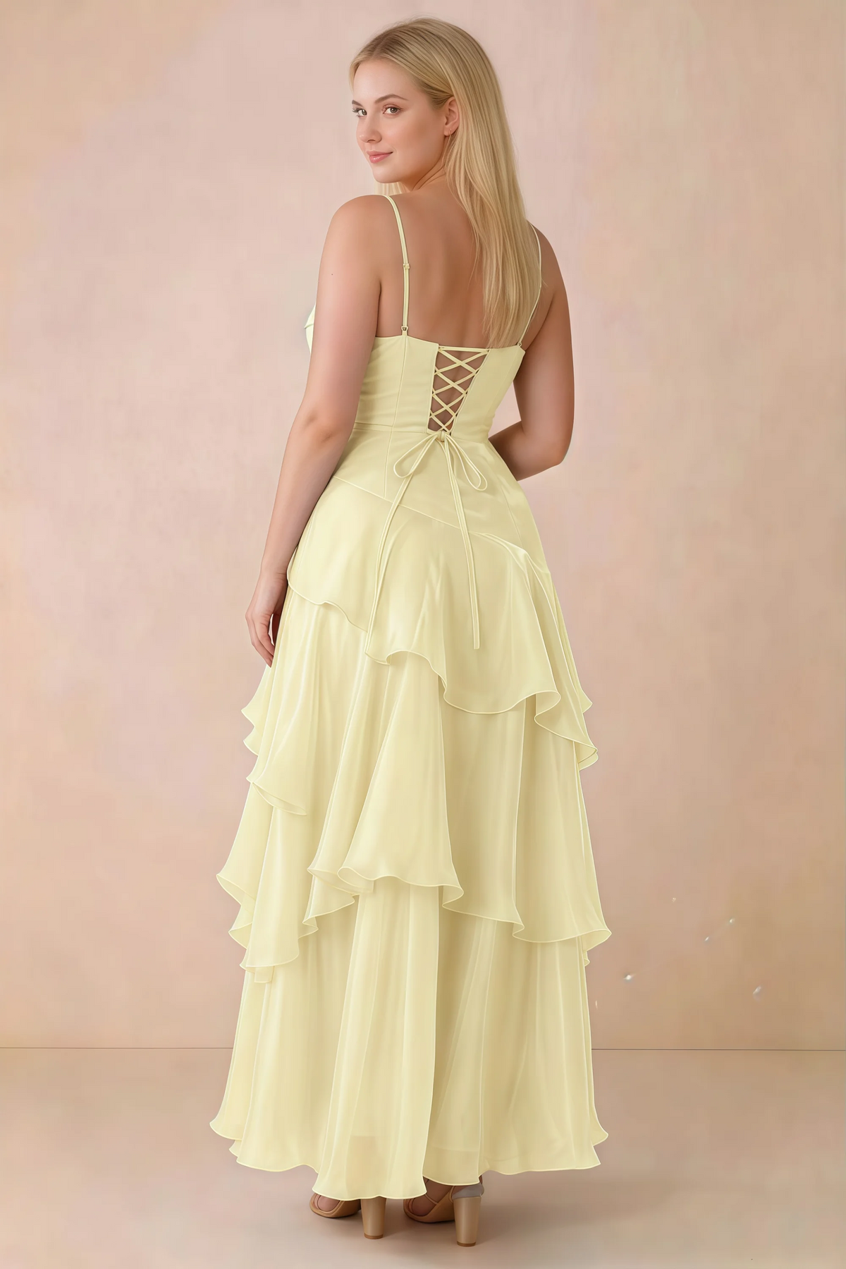Rear studio view of Ava lemon maxi dress showing the lace-up bodice and long tiered skirt