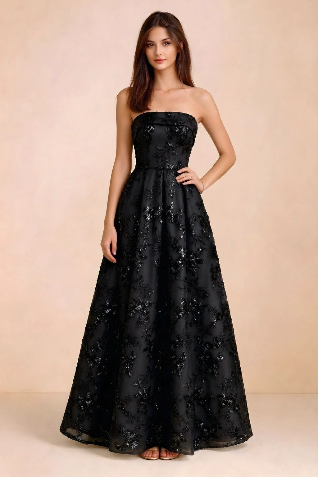 Front view of Avis black floral sequin strapless maxi dress with a fitted waist and full A-line skirt