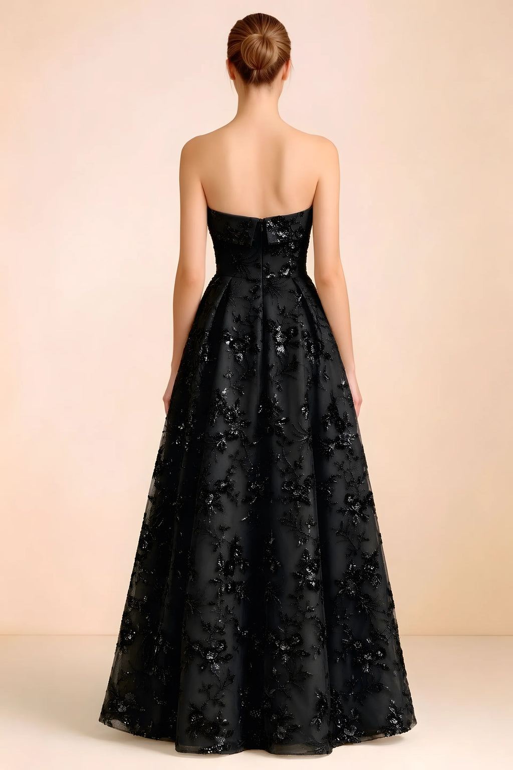 Back view of Avis black strapless sequin dress showing the fitted bodice and floor-length skirt