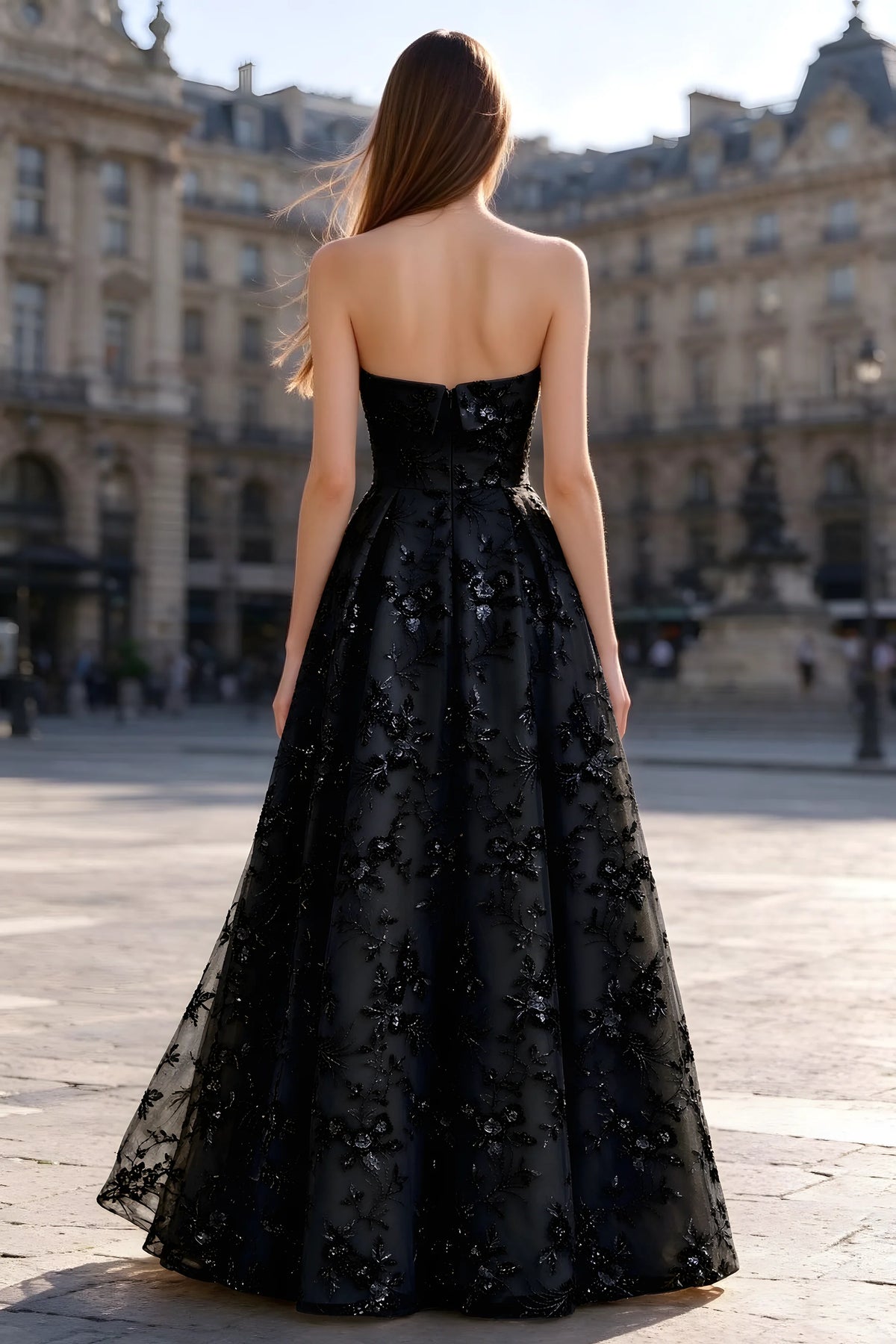 Rear courtyard view of Avis black strapless maxi dress and wide pleated skirt