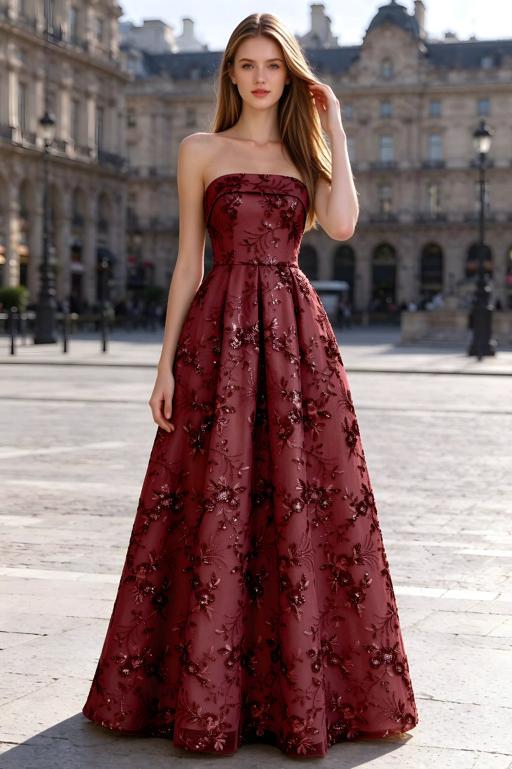 Avis burgundy floral sequin A-line maxi dress shown from the front in a stone courtyard