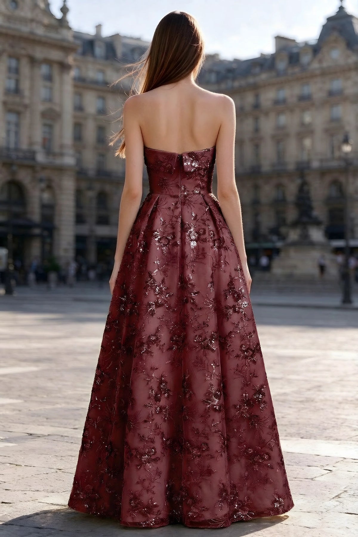 Rear courtyard view of Avis burgundy strapless maxi dress and wide pleated skirt