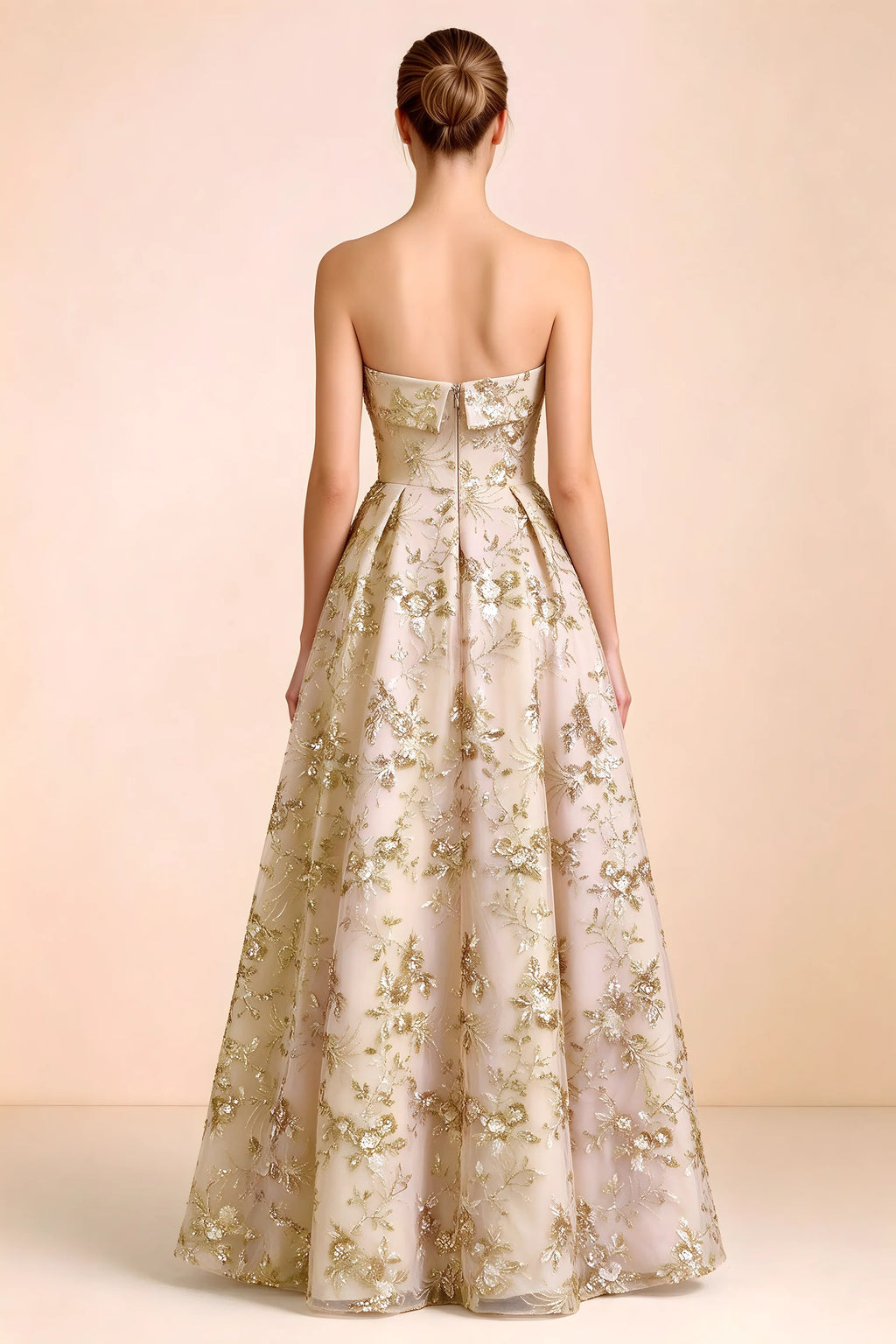 Back view of Avis champagne strapless sequin dress showing the fitted bodice and floor-length skirt