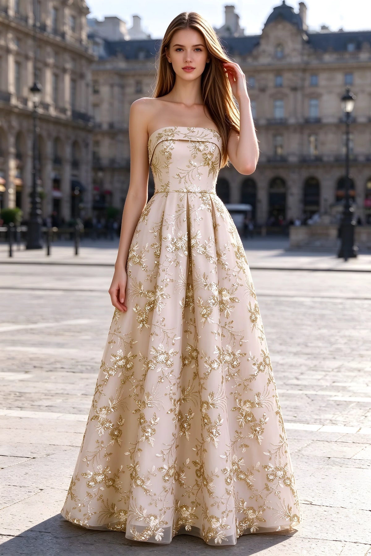 Avis champagne floral sequin A-line maxi dress shown from the front in a stone courtyard
