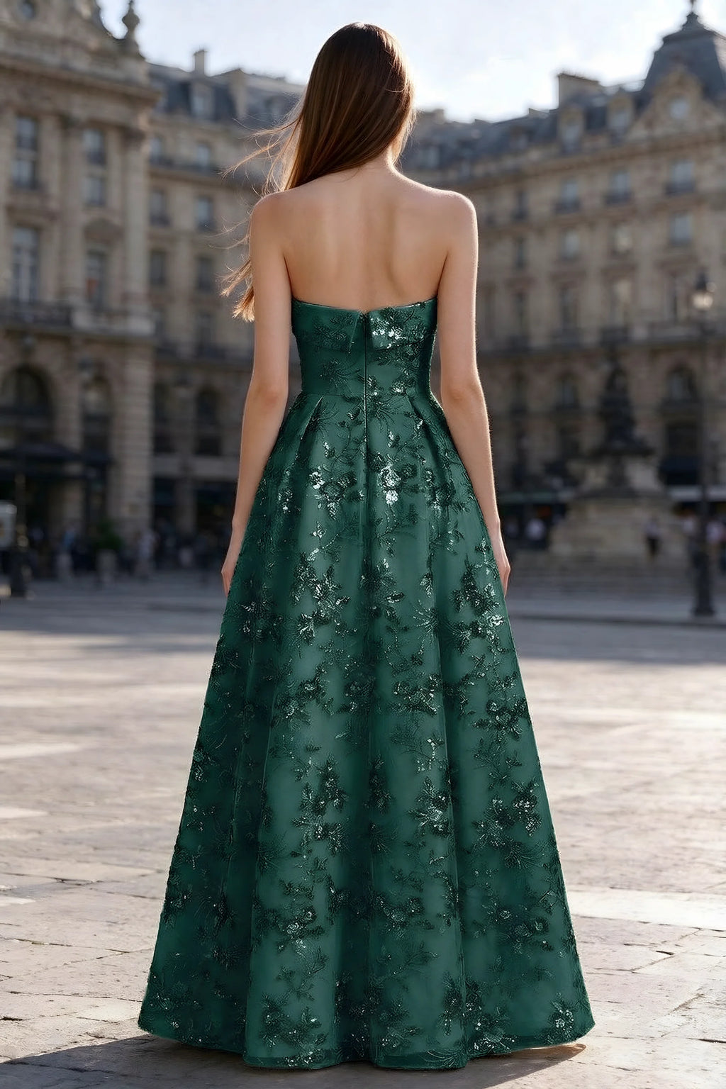 Rear courtyard view of Avis emerald green strapless maxi dress and wide pleated skirt