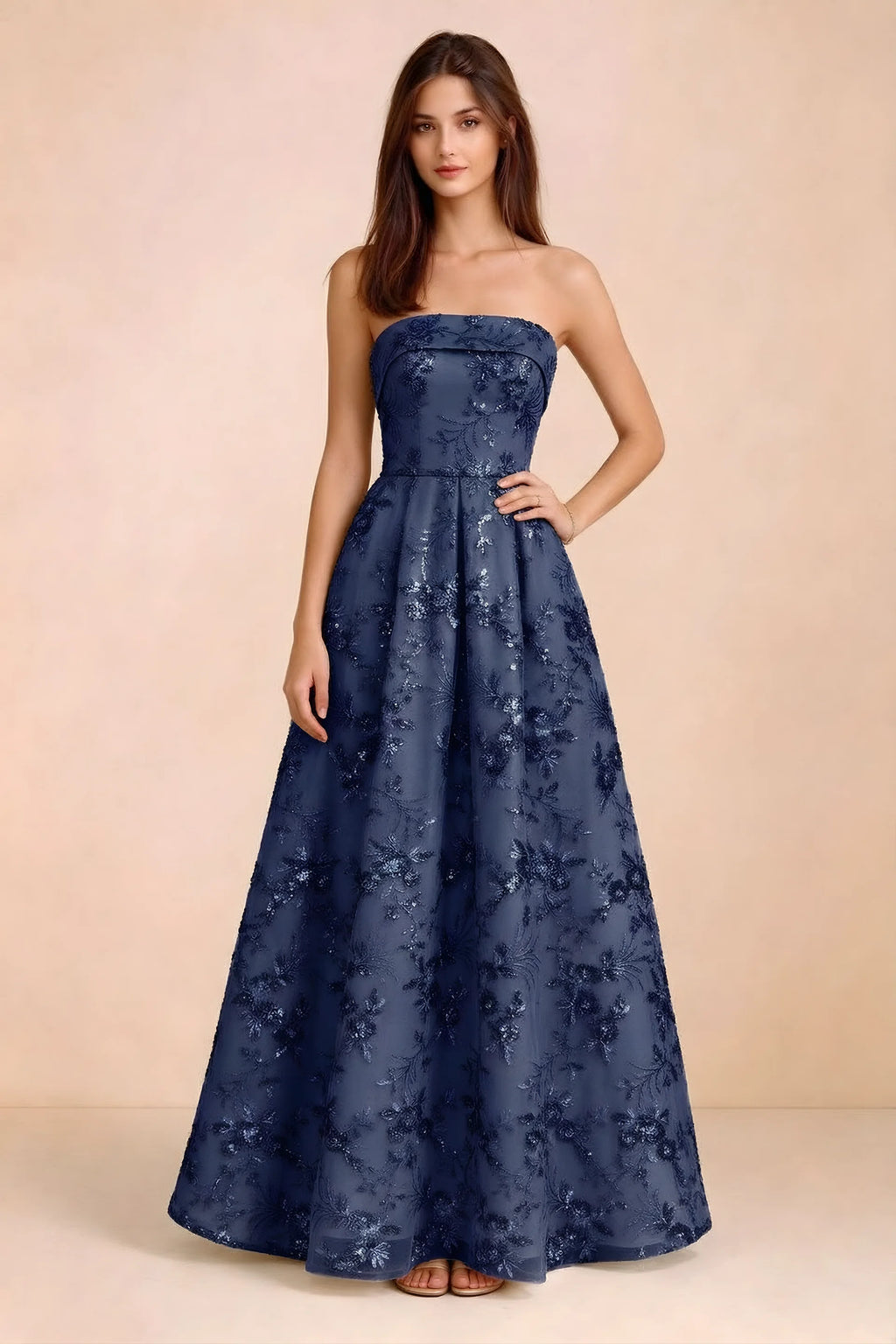 Front view of Avis navy floral sequin strapless maxi dress with a fitted waist and full A-line skirt