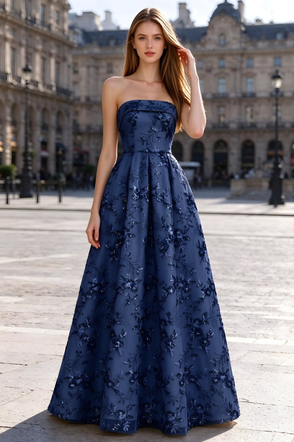Avis navy floral sequin A-line maxi dress shown from the front in a stone courtyard
