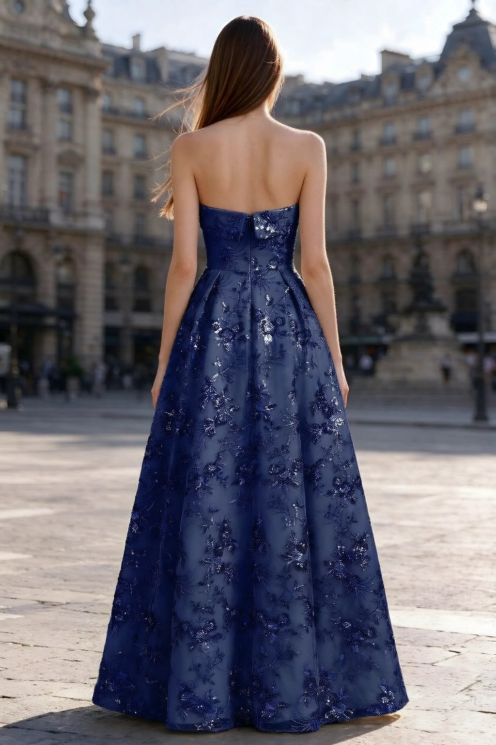 Rear courtyard view of Avis navy strapless maxi dress and wide pleated skirt