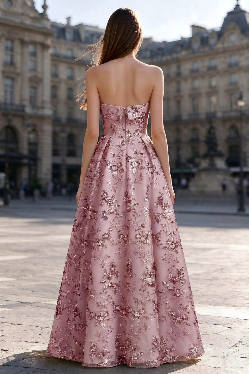 Rear courtyard view of Avis pink strapless maxi dress and wide pleated skirt