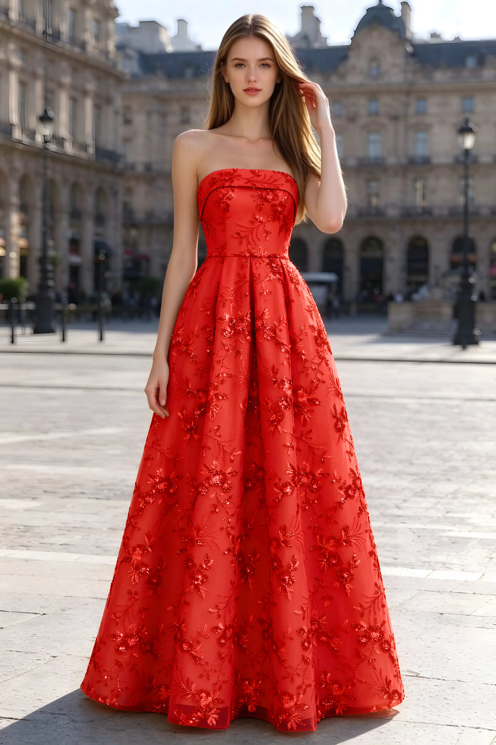 Avis red floral sequin A-line maxi dress shown from the front in a stone courtyard
