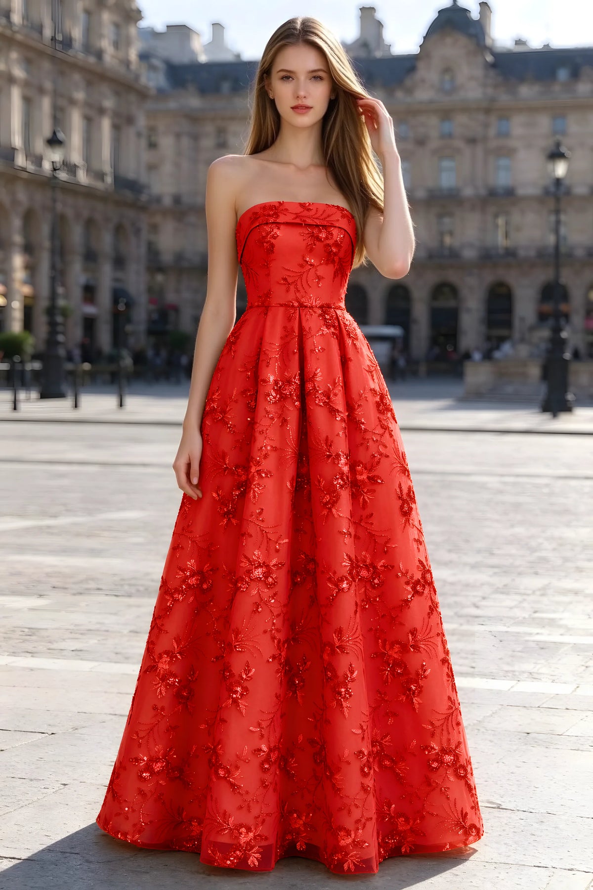 Avis red floral sequin A-line maxi dress shown from the front in a stone courtyard