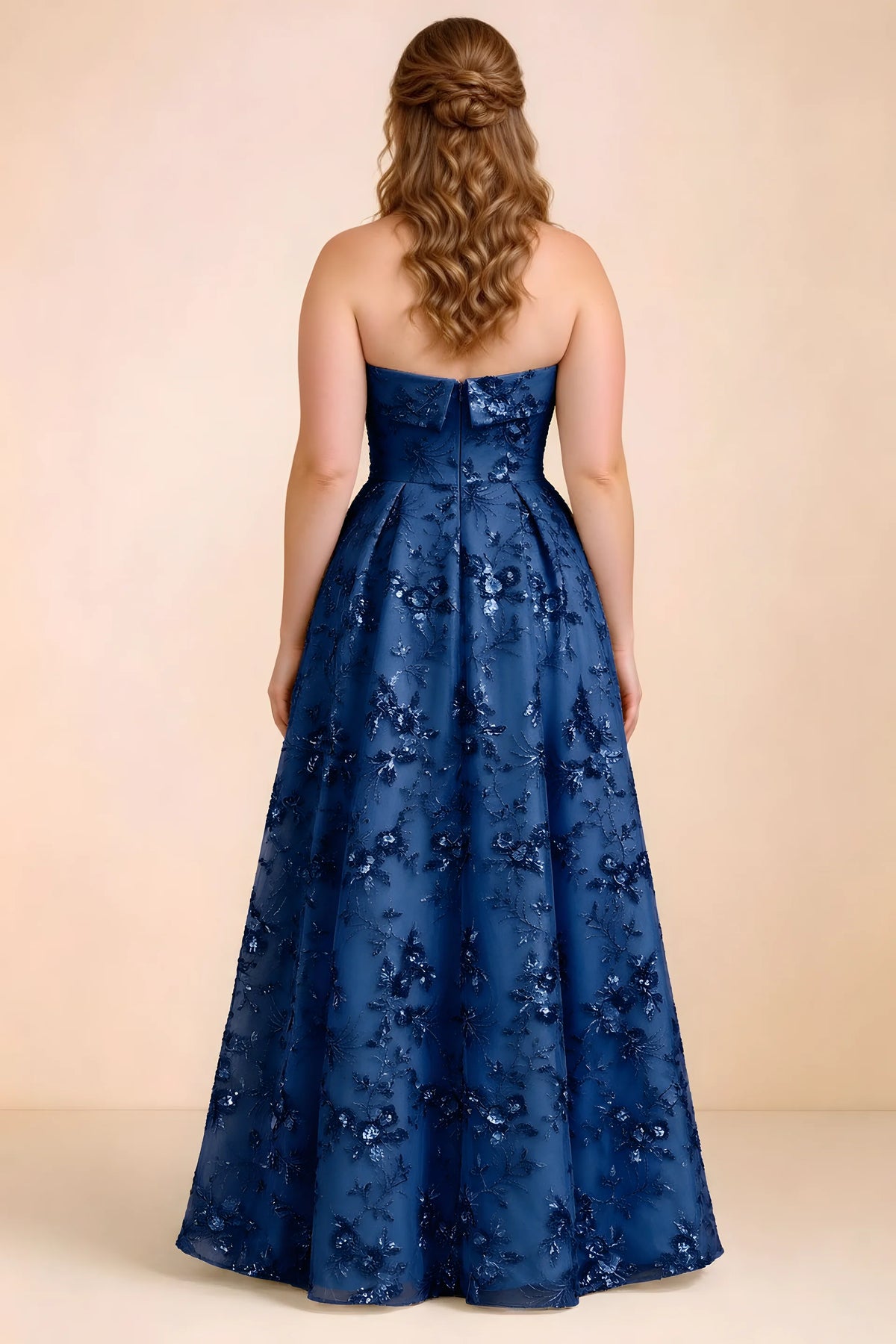 Rear studio view of Avis royal blue floral sequin dress showing the bodice and flowing A-line hem