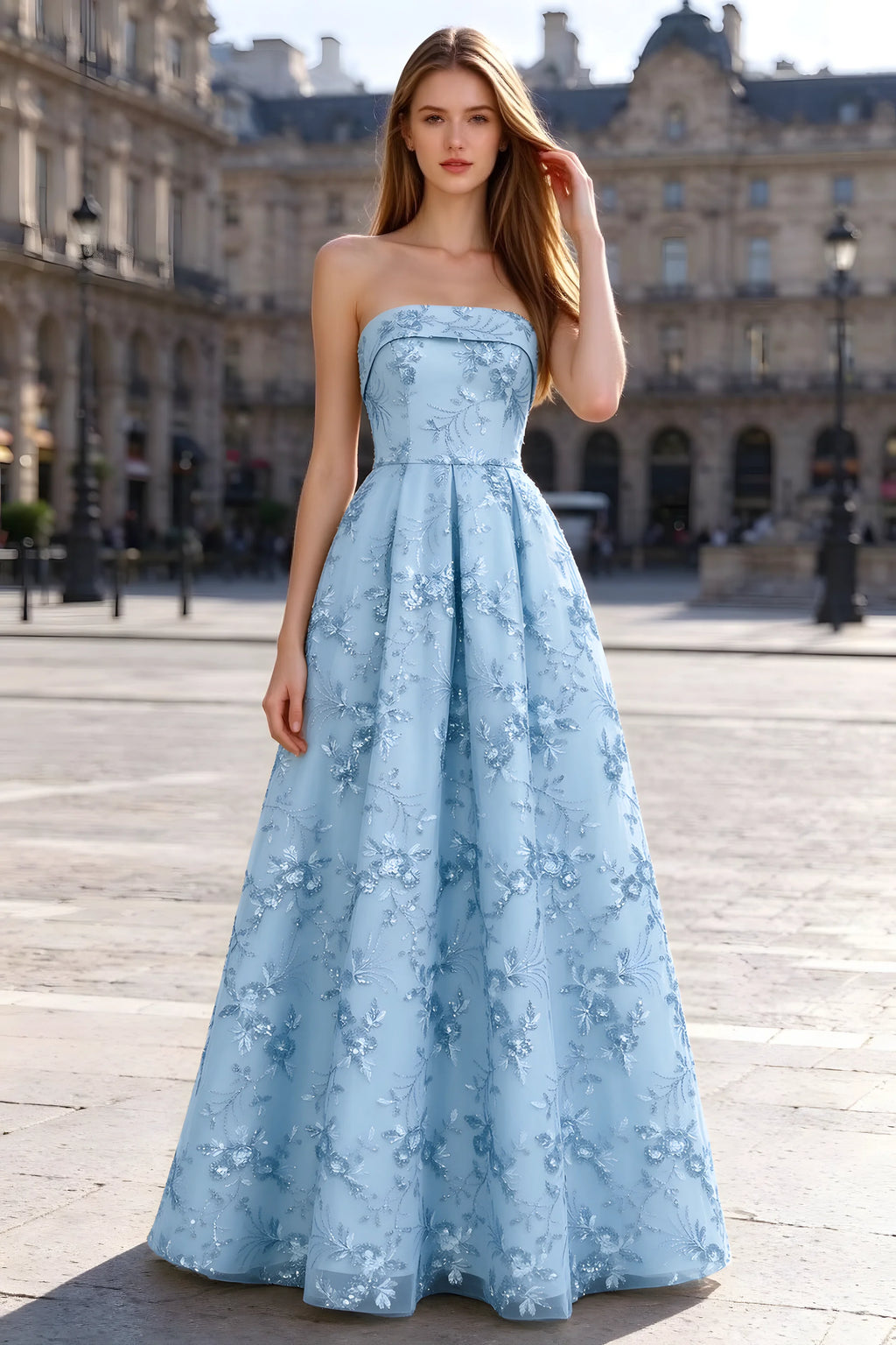 Avis sky blue floral sequin A-line maxi dress shown from the front in a stone courtyard