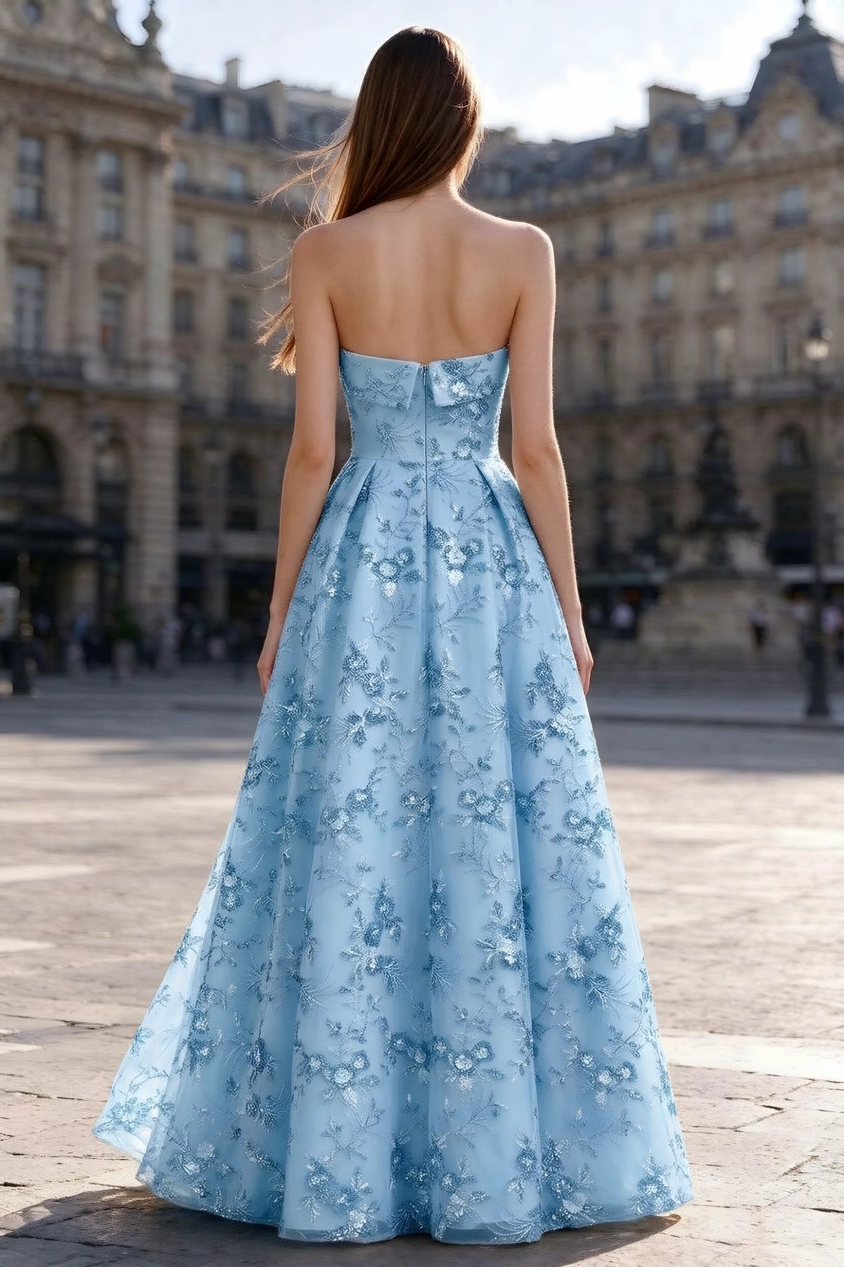 Rear courtyard view of Avis sky blue strapless maxi dress and wide pleated skirt