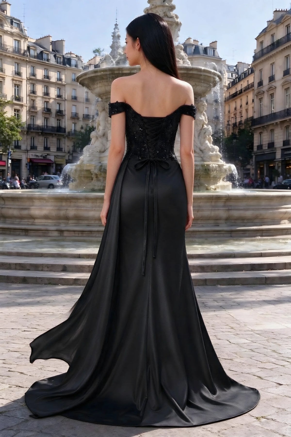 Rear outdoor view of Beatrix black satin dress with back lacing and a flared floor-length hem
