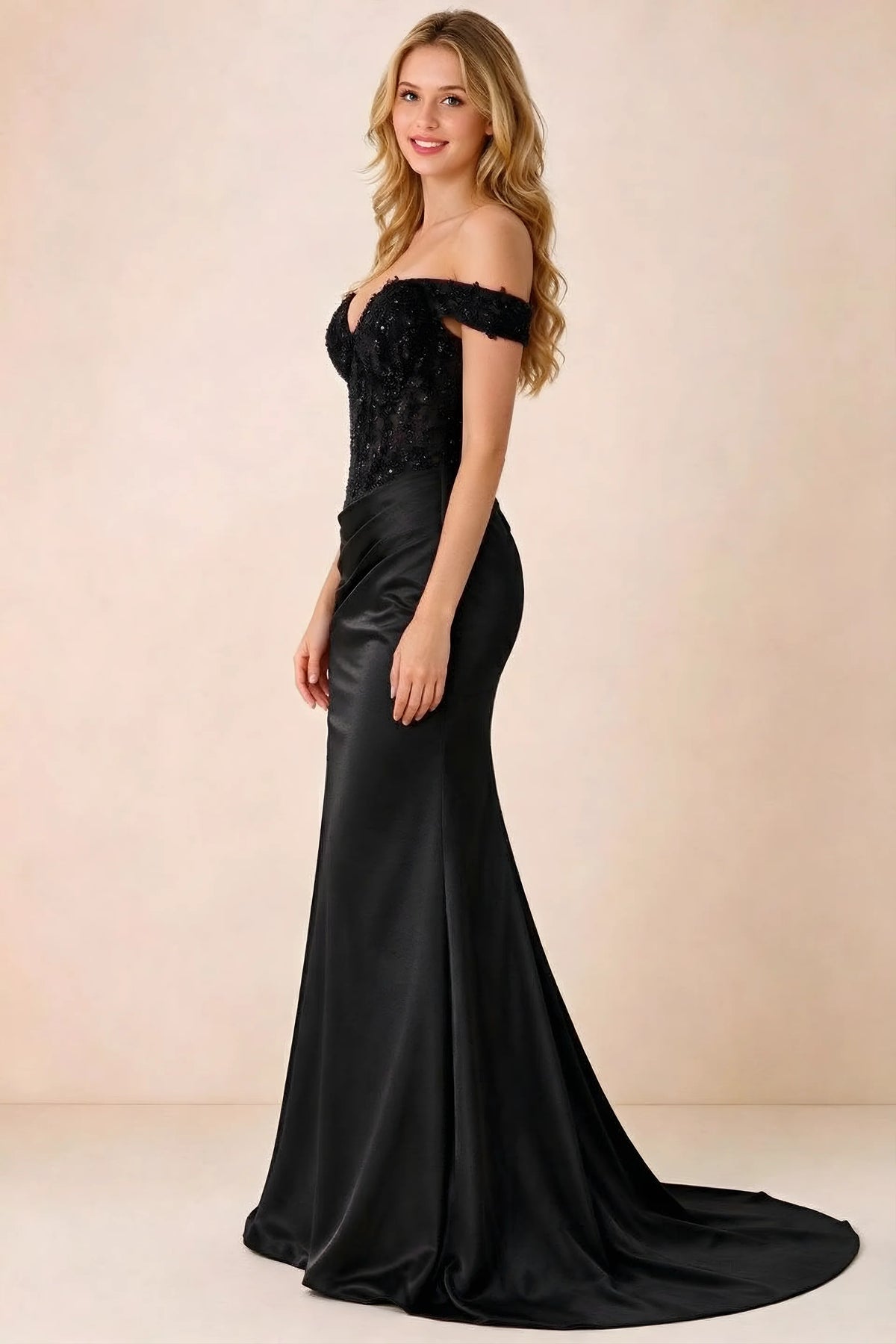 Side view of Beatrix black maxi dress showing the fitted hips and draped skirt