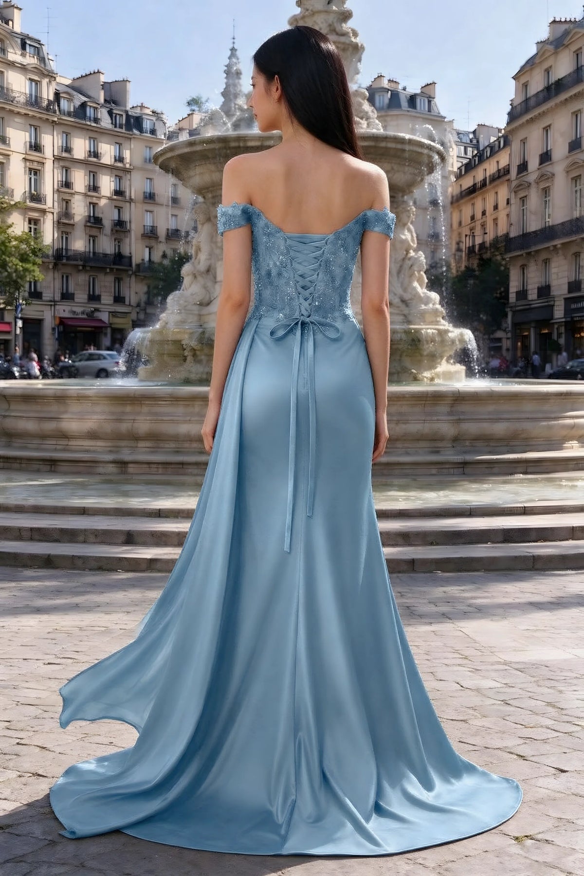 Rear outdoor view of Beatrix dusty blue satin dress with back lacing and a flared floor-length hem