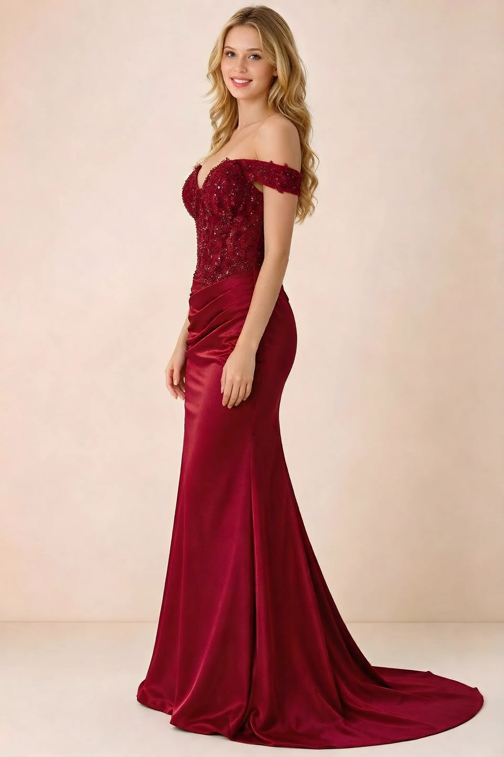 Side view of Beatrix red maxi dress showing the fitted hips and draped skirt