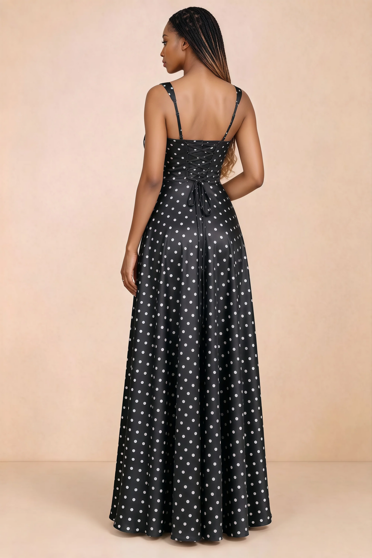 Back studio view of Becky black polka dot satin maxi dress showing shoulder straps and waist-length lacing
