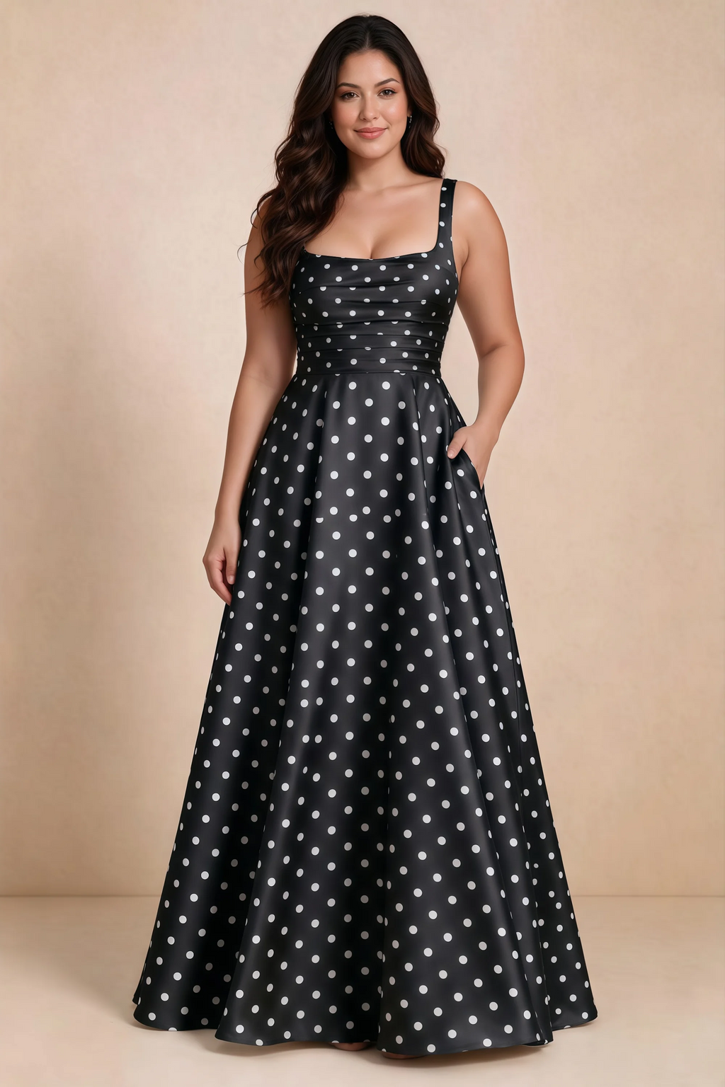 Front studio view of Becky black polka dot satin maxi dress showing the defined waist and flowing skirt
