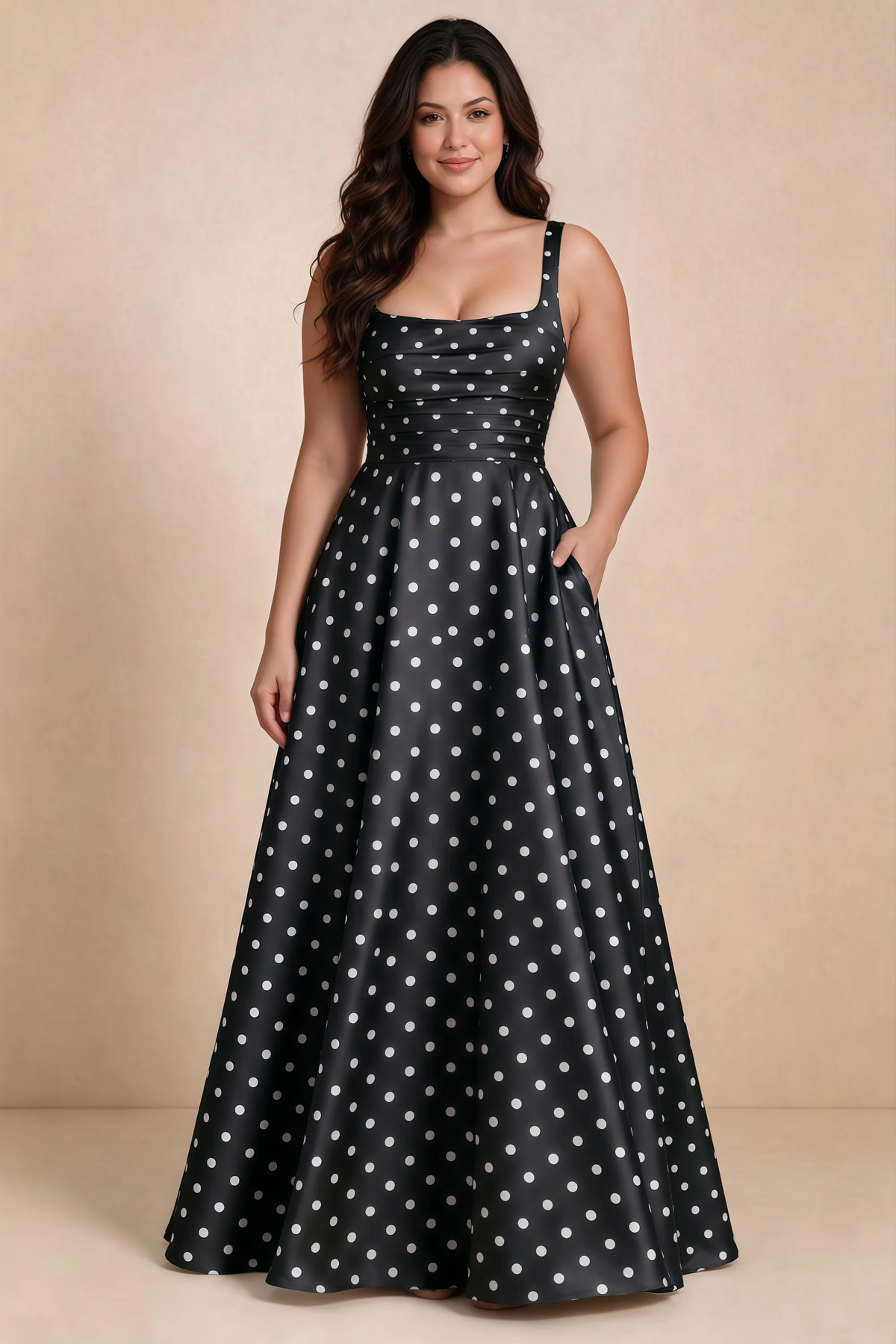 Front studio view of Becky black polka dot satin maxi dress showing the defined waist and flowing skirt