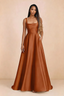 Front studio view of Becky rust satin maxi dress showing the square neckline, pleated bodice and full A-line skirt