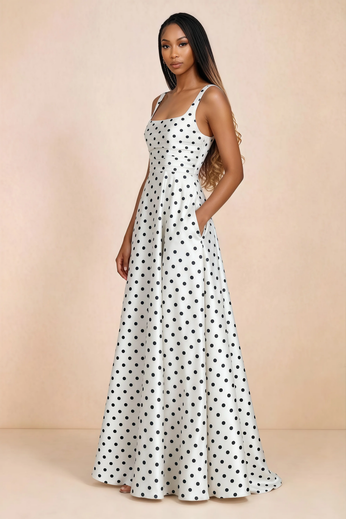 Three-quarter studio view of Becky white polka dot satin maxi dress with a hand resting in the side pocket