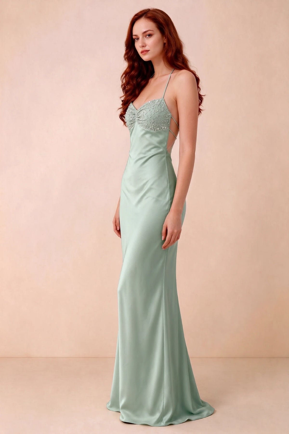 Three-quarter studio view of Blanche agave dress showing the fitted hips and flared long hem