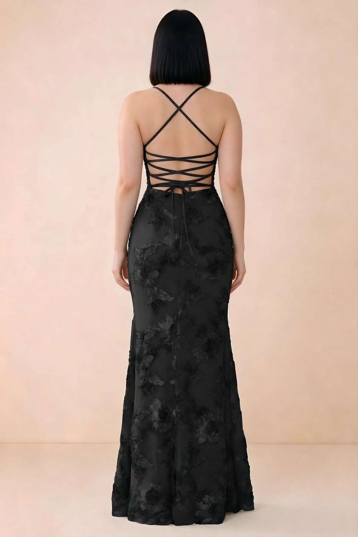 Rear studio view of Belinda black dress showing the open back and gently flared skirt
