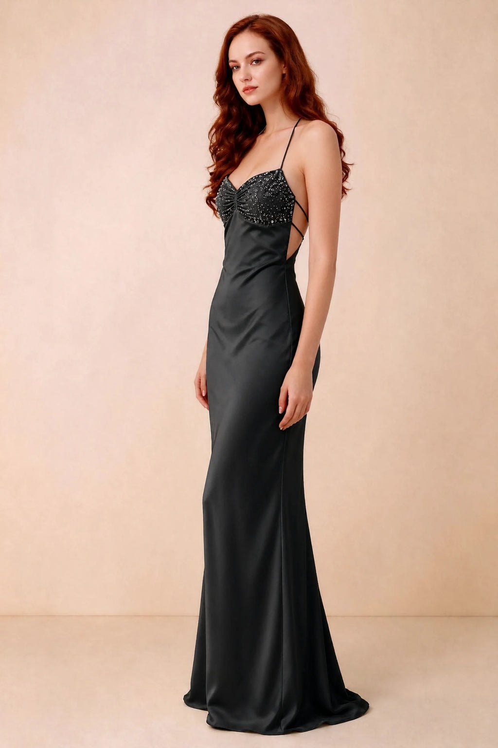 Three-quarter studio view of Blanche black dress showing the fitted hips and flared long hem