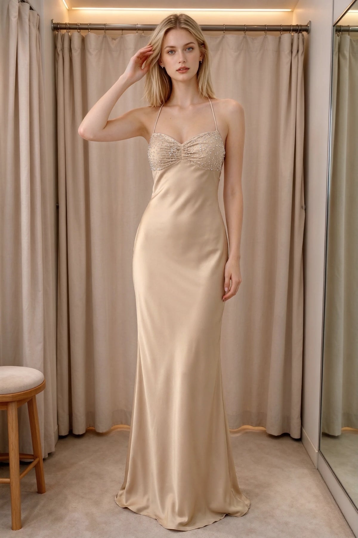 Front indoor view of Blanche champagne satin maxi dress beside curtains with a beaded bust panel