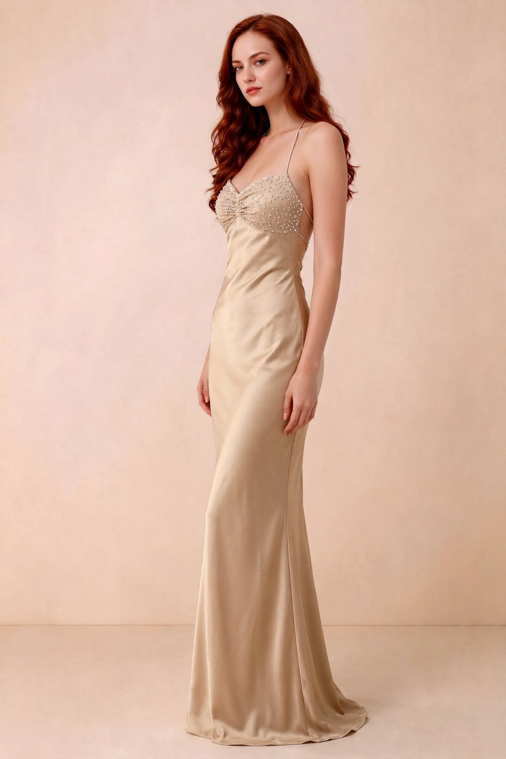 Three-quarter studio view of Blanche champagne dress showing the fitted hips and flared long hem