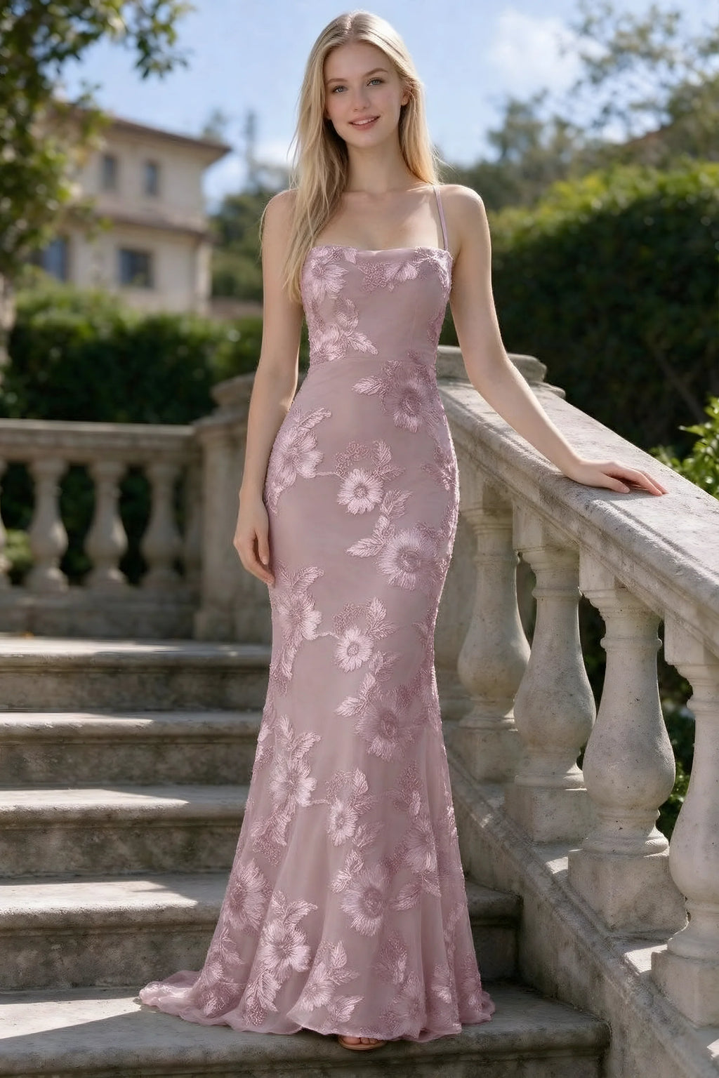 Outdoor front view of Belinda dusty lilac floral lace mermaid dress on stone steps