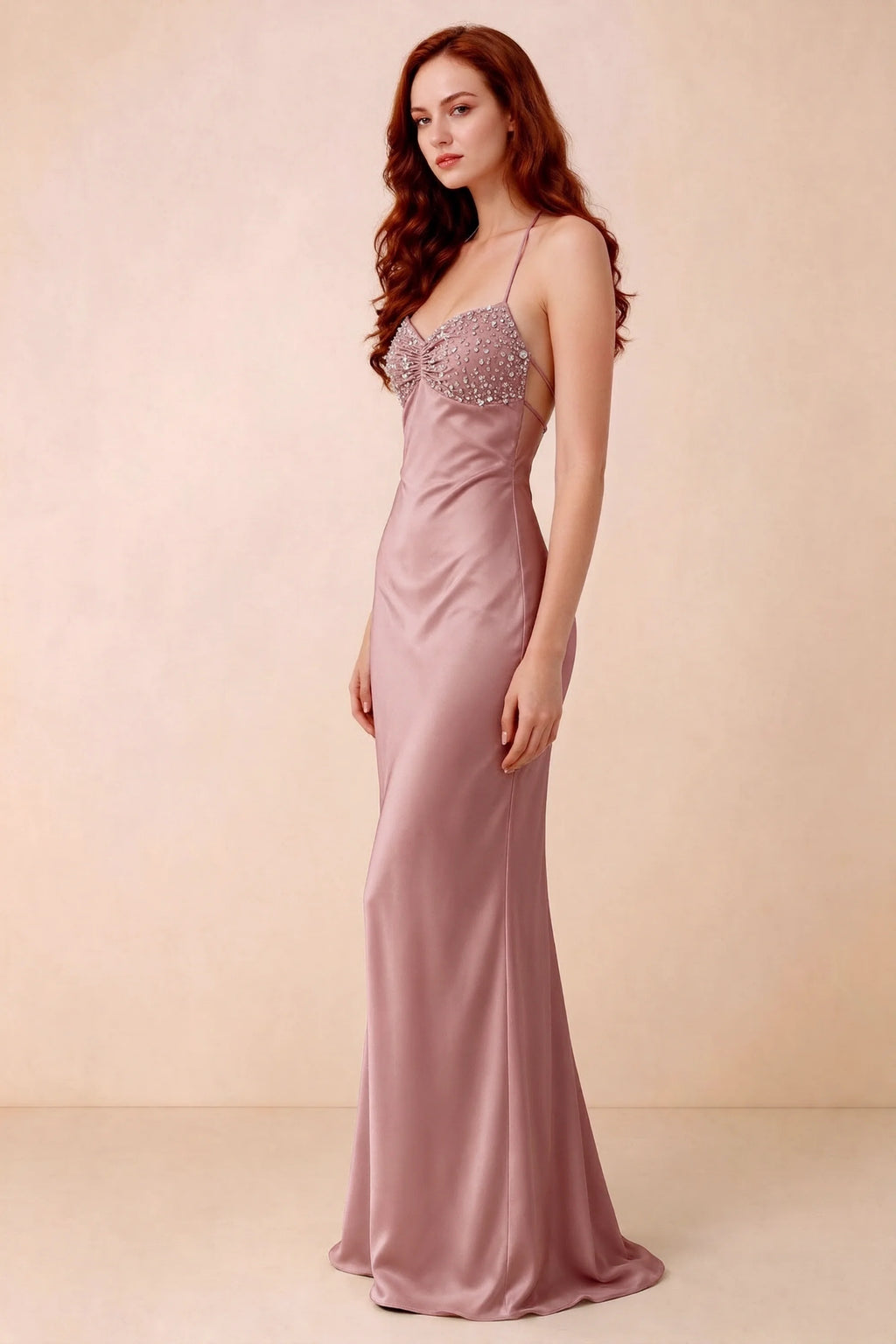 Three-quarter studio view of Blanche dusty pink dress showing the fitted hips and flared long hem