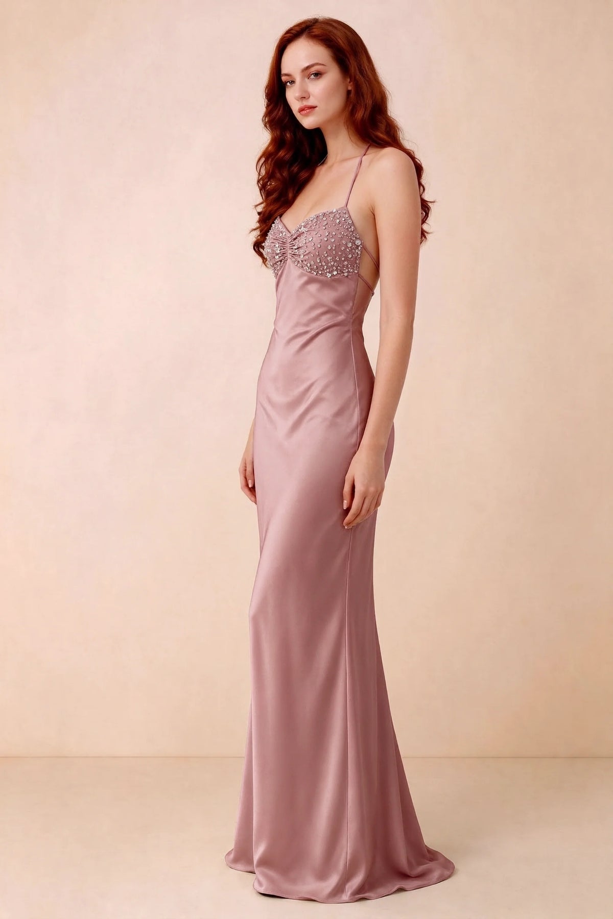 Three-quarter studio view of Blanche dusty pink dress showing the fitted hips and flared long hem