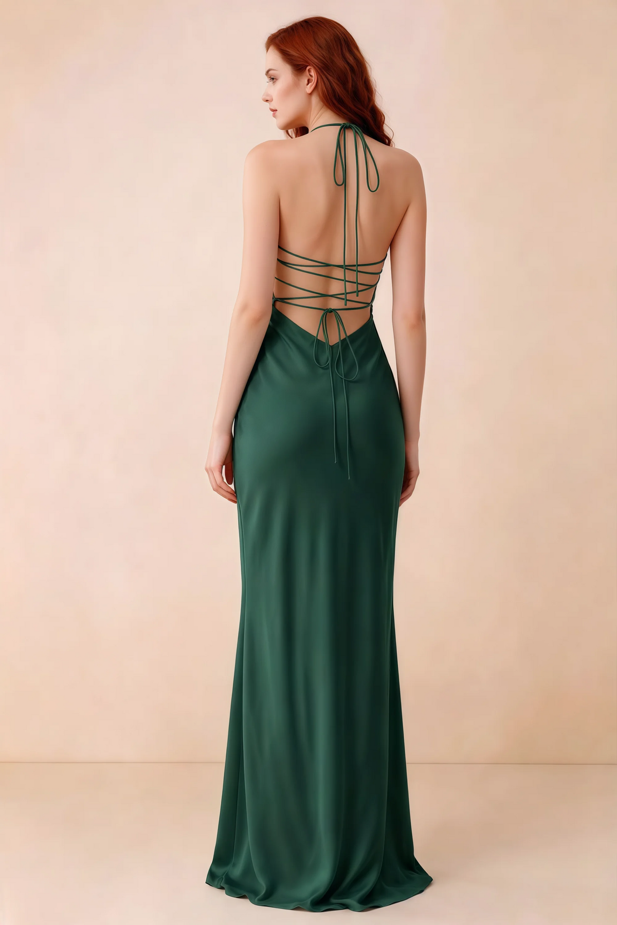 Back studio view of Blanche emerald green dress showing halter neck ties and crossed open-back lacing
