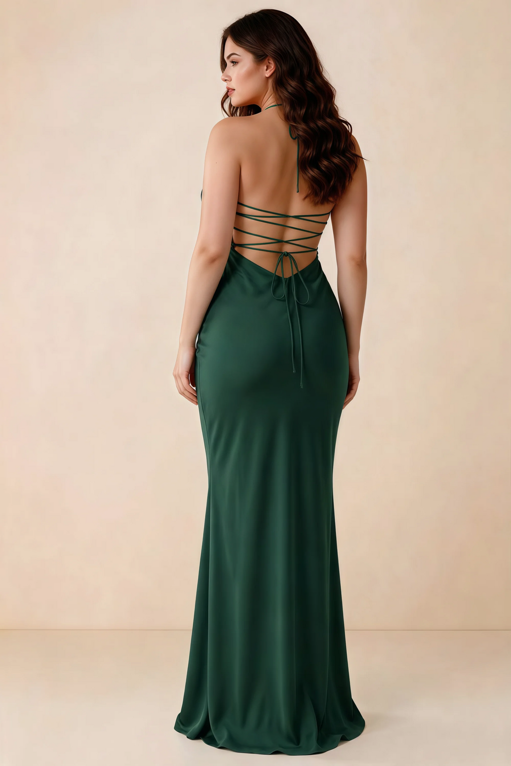 Rear studio view of Blanche emerald green satin dress showing the open back and mermaid silhouette