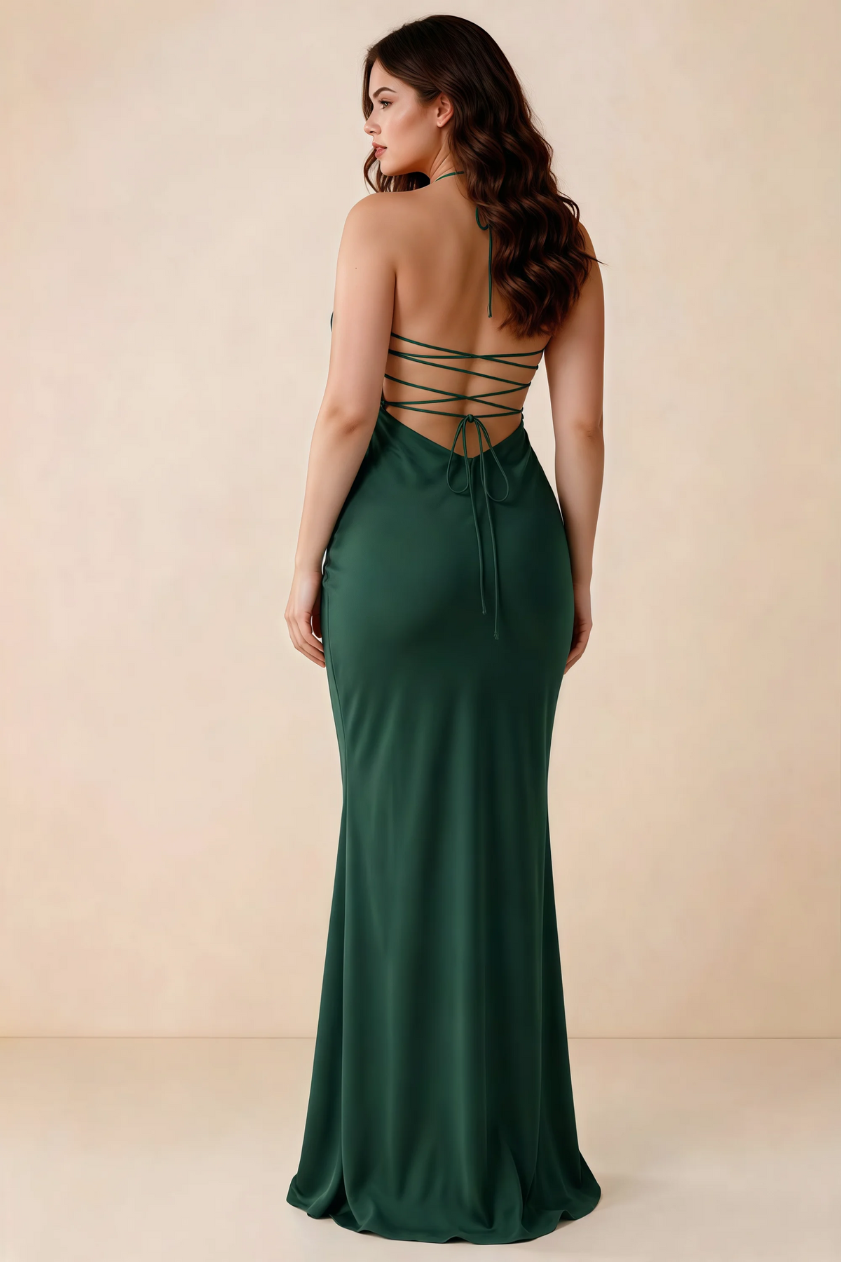 Rear studio view of Blanche emerald green satin dress showing the open back and mermaid silhouette