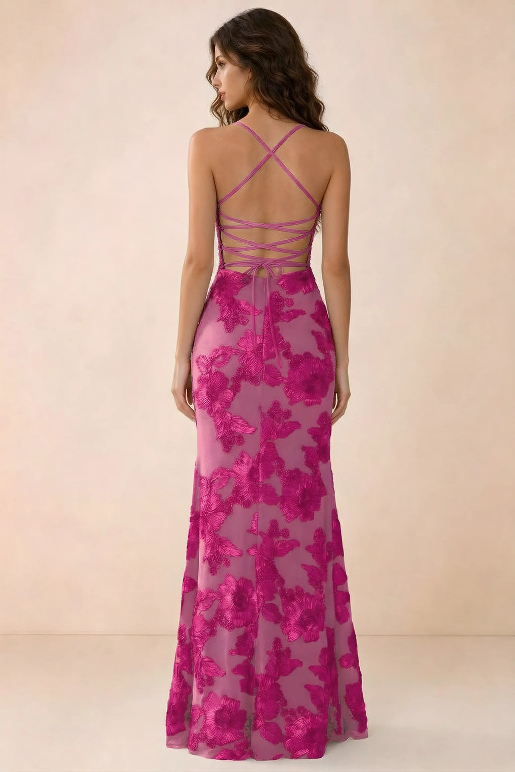Back studio view of Belinda fuchsia maxi dress showing crossed straps and open-back ties