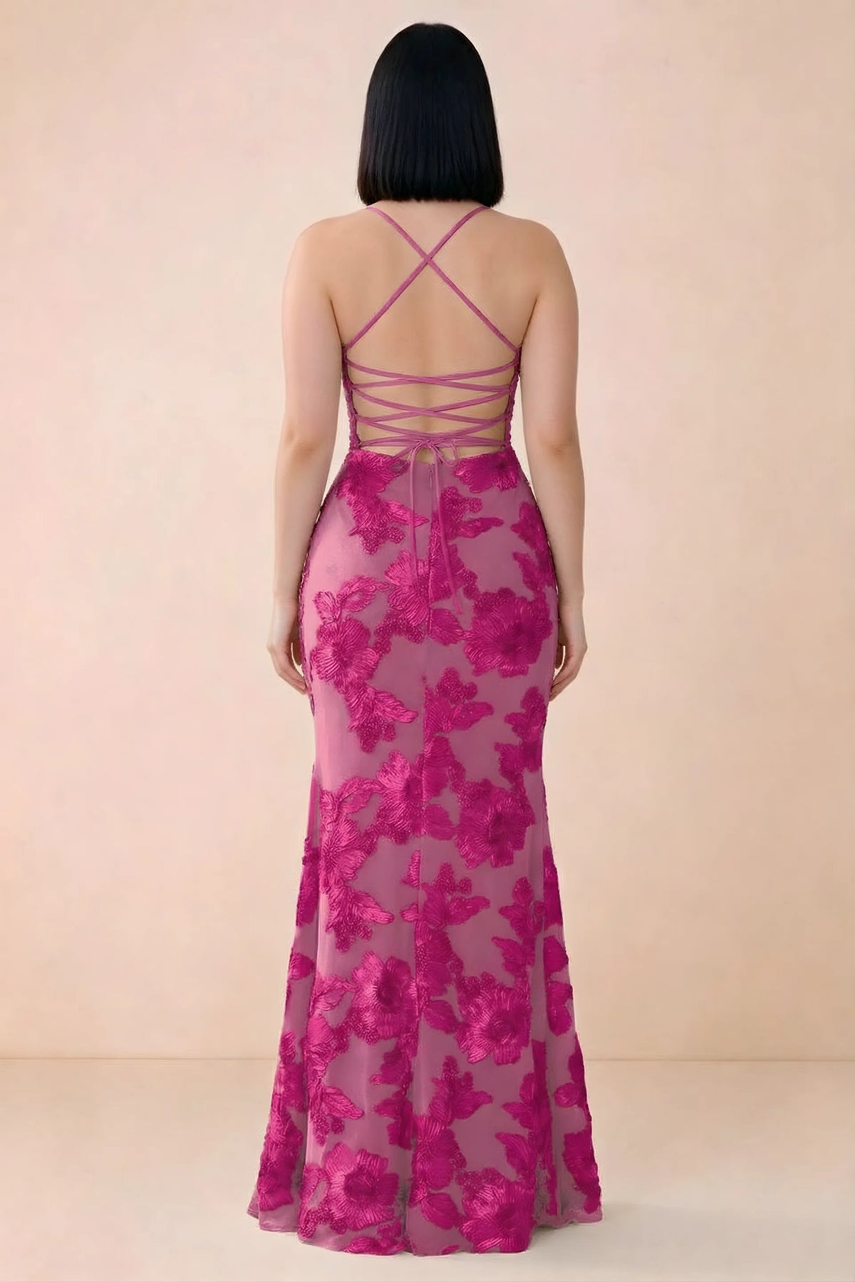 Rear studio view of Belinda fuchsia dress showing the open back and gently flared skirt